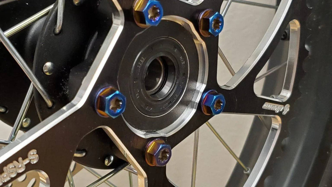Warp 9 E-Moto rear sprocket titanium bolts in burnt blue anodized finish with dual drive heads and blue thread lock