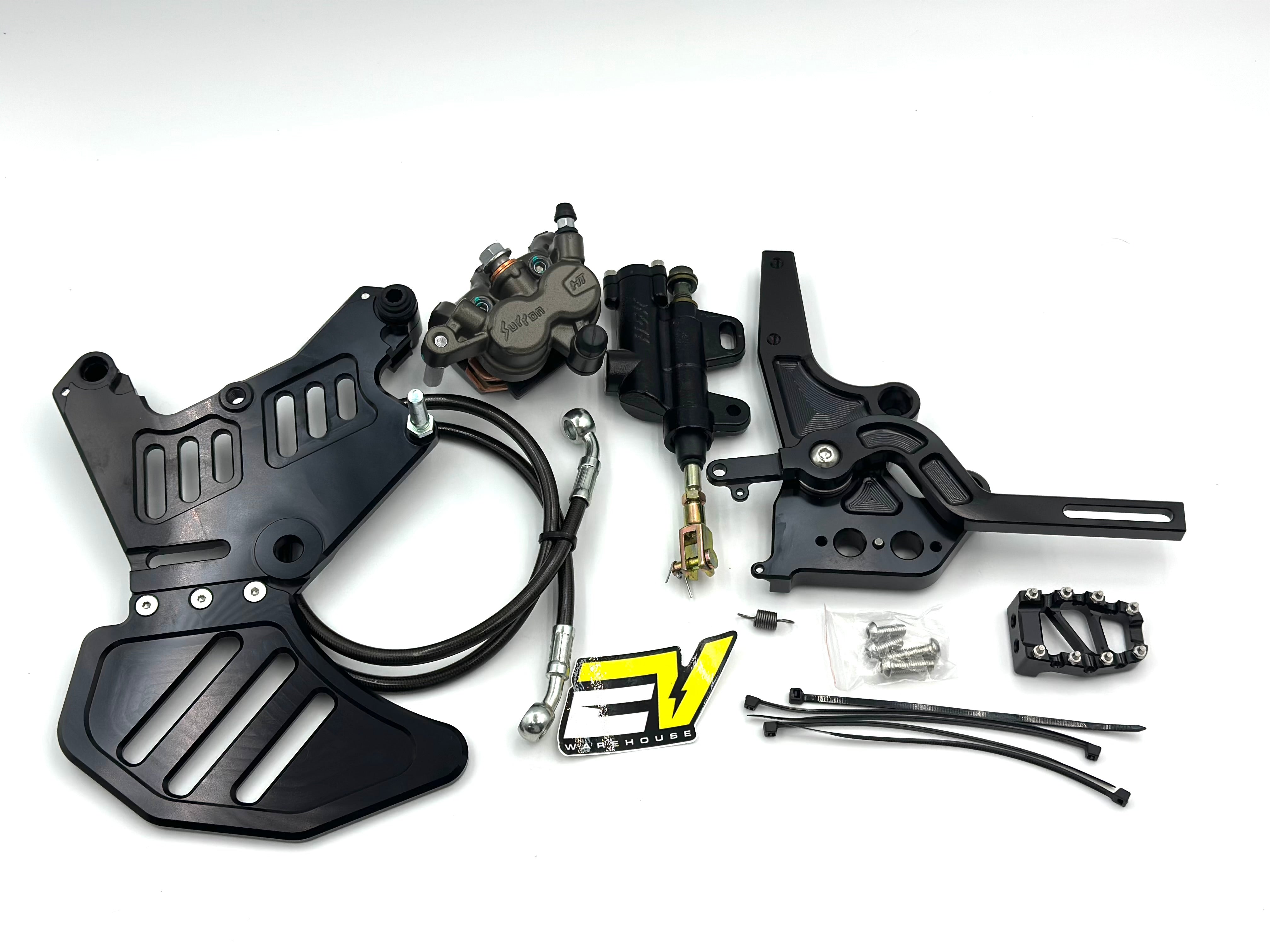 A motorcycle brake and clutch kit laid out on a white background, including black metal plates, a black brake master cylinder, a black clutch assembly with a yellow and black logo, mounting hardware, and cables.