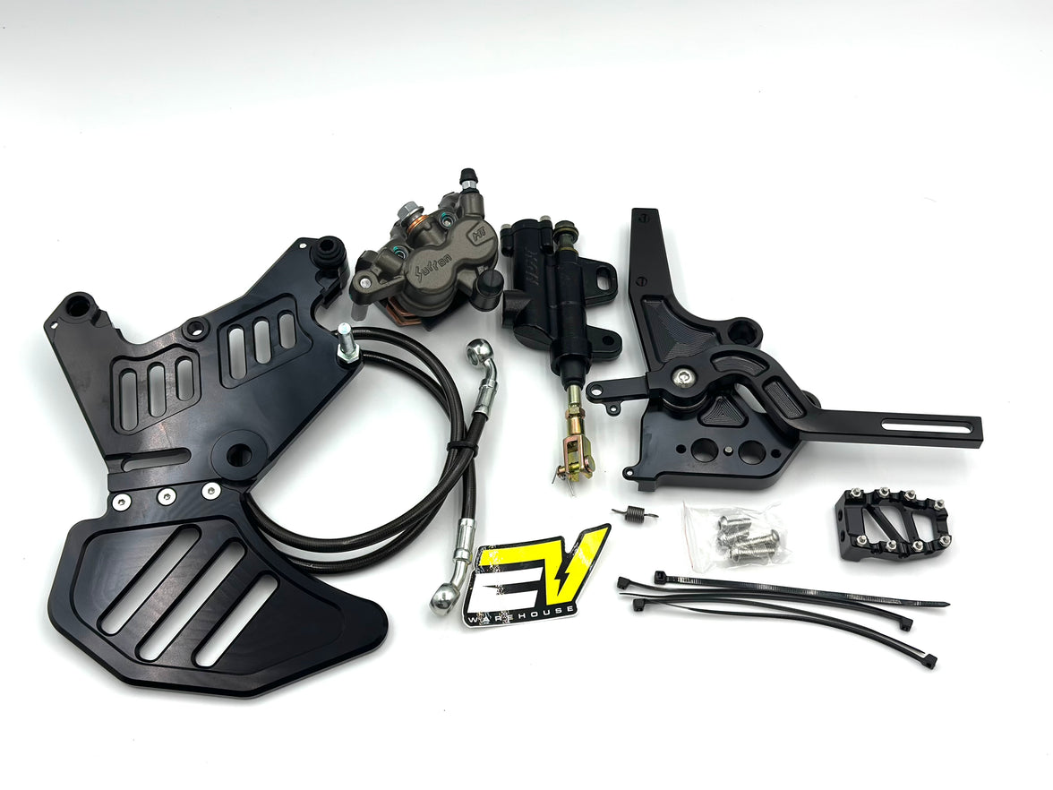 A motorcycle brake and clutch kit laid out on a white background, including black metal plates, a black brake master cylinder, a black clutch assembly with a yellow and black logo, mounting hardware, and cables.