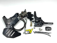 A motorcycle brake and clutch kit laid out on a white background, including black metal plates, a black brake master cylinder, a black clutch assembly with a yellow and black logo, mounting hardware, and cables.