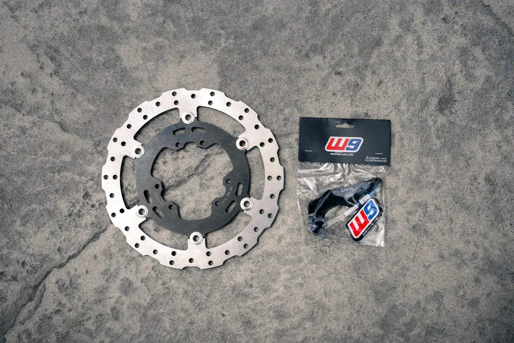 Warp 9 Ultra Bee 300mm rotor and caliper bracket for enhanced braking performance on Surron Ultra Bee Supermoto bike