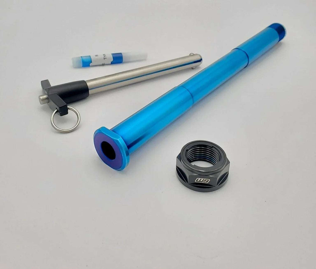 Warp 9 Surron Ultra Bee titanium rear axle with quick pull tee handle and burnt blue anodized finish