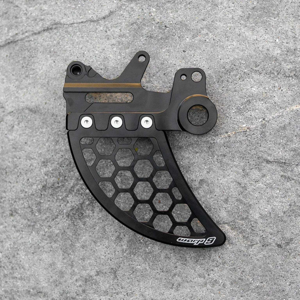 Warp 9 Ultra Bee Disk Guard made from CNC-cut 7075-T6 aluminum protecting E-Moto braking system