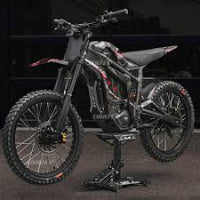 Electric dirt bike on a stand with a dark background